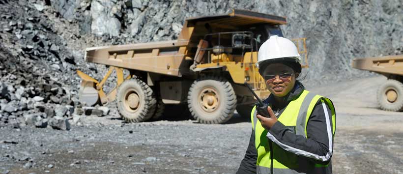 Woman at mine site holding radio